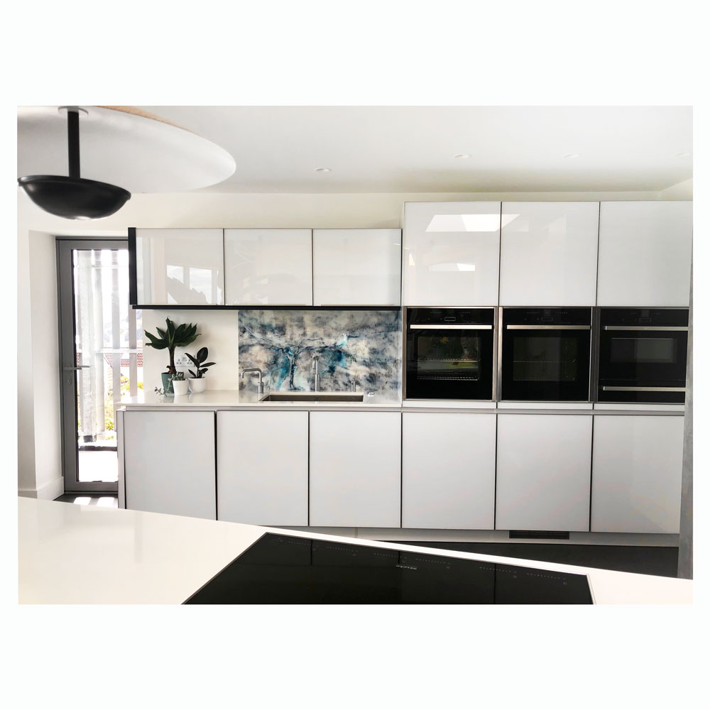 modern kitchen with blue abstract acrylic splashback.